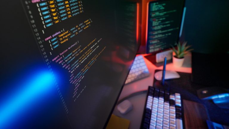 A developer working on a WordPress website with code on a laptop screen.