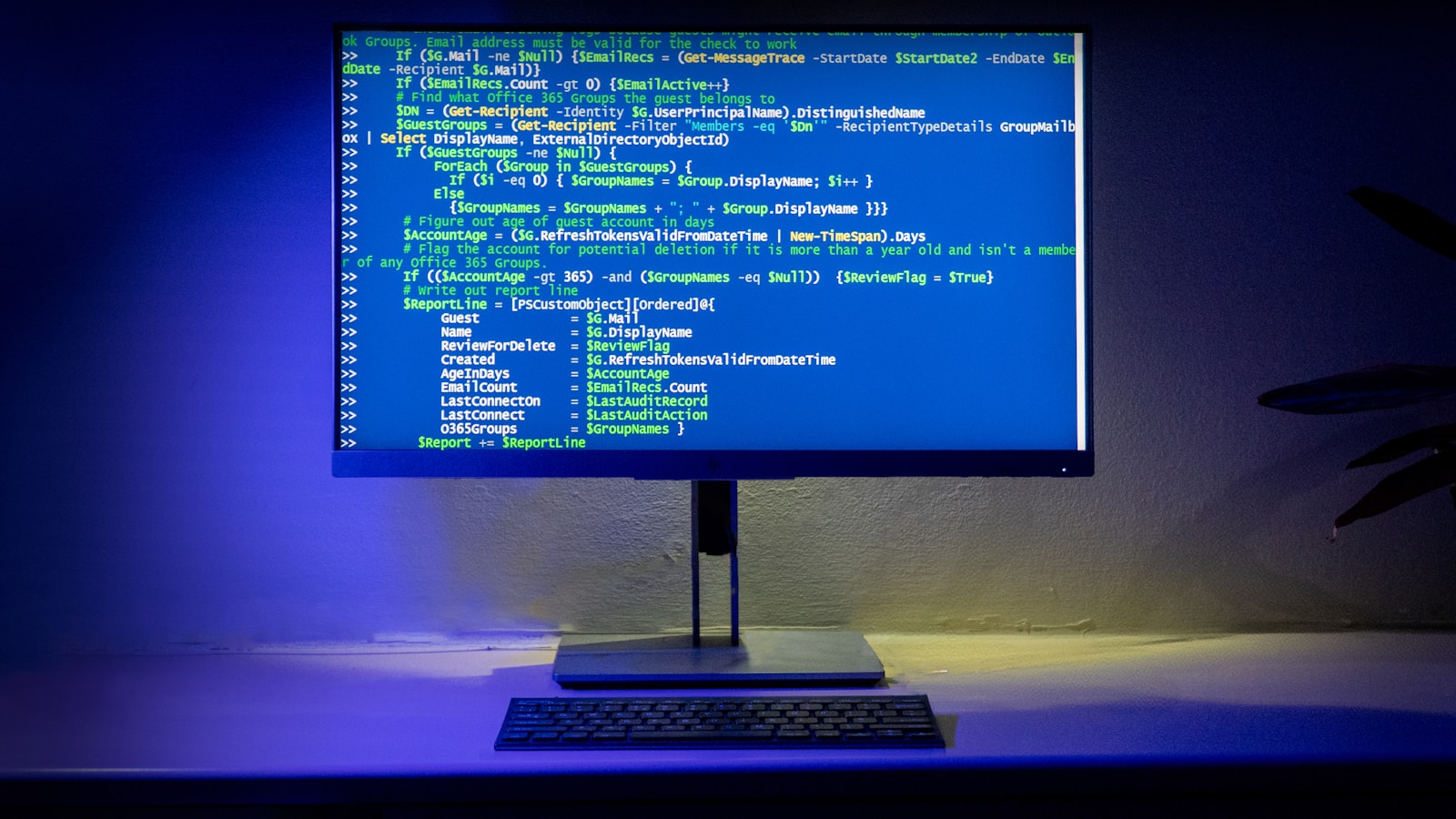 A developer workspace showing code, analytics, and a laptop on a clean desk